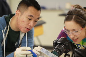 Jeffrey Ng, left, shows Juliane Hough how to photograph an image of a fingerprint during a lab session of the Texas Forensic Science Academy's Latent Print Processing course