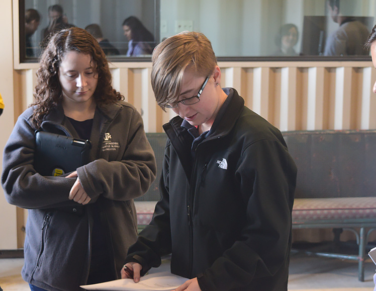 Stephanie Stratta, left, and Whitney West discussing notes during the mock crime scene exercise. 