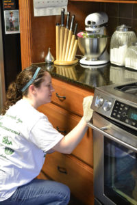Stephanie Stratta cleaning the kitchen. Photo by Melissa Espinoza.