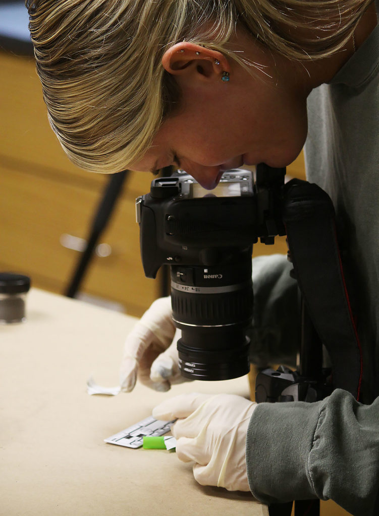 Journey Ewell capturing a fingerprint with a camera