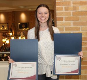 Michelle Jonika with her two awards. Photo by Rob Williams