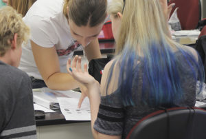 Zanthe Kotze showing a student the basics of fingerprint analysis. Photo by Rob Williams