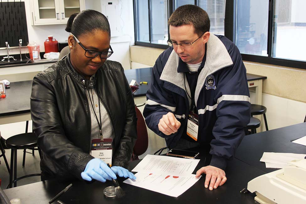 Ina Knight, left and Brandon Pigeon, right, learn how to use the tools forensic scientists use to do casework with.