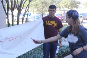 Students in Dr. Adrienne Brundage's FIVS 205 Intro to Forensics course learning bloodspatter patterns. Photo by Rob Williams