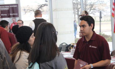 Aggieland Saturday participants talking to one of our students